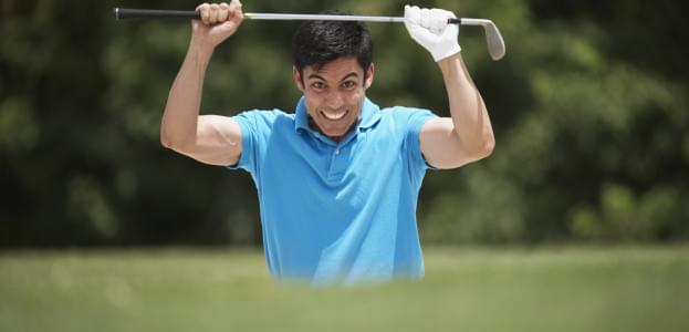 Frustrated Hispanic man holding golf club